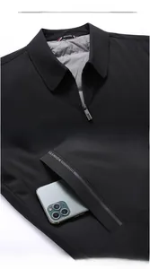 Detailed close-up of men's winter jacket collar and zippered pocket with fashion tag