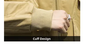 Detailed close-up of khaki cotton jacket sleeve featuring a ribbed cuff and fine stitching