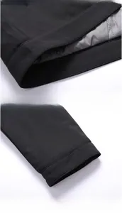 Detail of black winter jacket sleeve cuff and smooth gray inner lining fabric