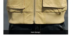 Close-up of khaki utility jacket featuring a ribbed elastic hem and metal zipper detail