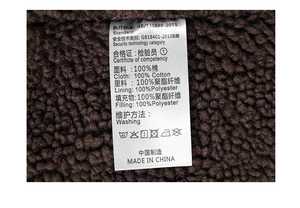 Detail of the washing label showing 100% cotton fabric and fleece lining on the jacket
