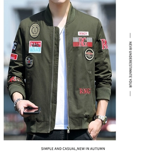 Close-up of military green bomber jacket with vintage embroidered patches and stand collar