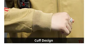 Detail of khaki jacket ribbed cuffs with embroidery and patches for windproof protection