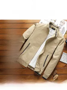 Detail of khaki men's casual jacket with stand collar and metal zipper on wood background