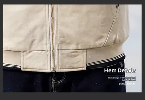 Macro detail of the windproof ribbed hem and golden zipper on men's winter jacket