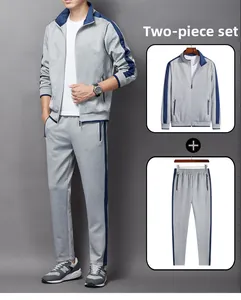 Detail of men's grey tracksuit showing zipper pockets and contrast side stripes