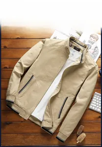Detailed close-up of khaki cotton jacket with metal zipper and ribbed striped cuffs