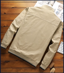 Detailed flat lay of a khaki stand collar jacket on a wooden background with magazine
