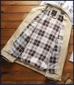 Detail view of khaki cotton jacket with plaid lining, stand collar and ribbed cuffs