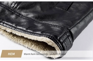 Close-up of the black PU leather jacket hem with warm off-white faux shearling lining