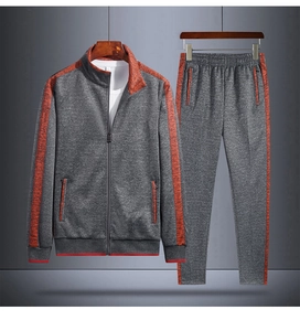 Detailed view of grey track suit with contrasting orange stripes and zipper pockets