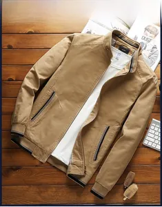 Detail of khaki cotton jacket with striped ribbed collar and cuffs on wooden background