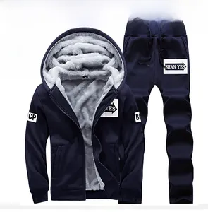 Detail of dark blue fleece-lined hoodie and sweatpants set showing soft grey inner lining