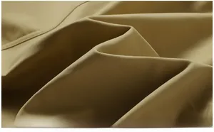 Close-up of premium khaki cotton twill fabric showing smooth texture and clear weave detail