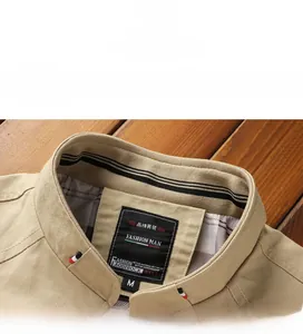 Detail view of khaki cotton jacket showing ribbed stand-up collar and checkered lining