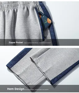 Detail of men's gray joggers featuring secure zipper pockets and contrast side stripes