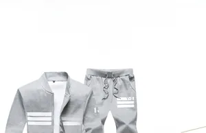 Flat lay of light gray tracksuit with white stripes and Y-8 logo on hoodie and pants