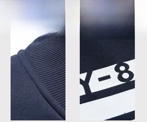 Detail of dark blue knit sweatshirt featuring ribbed collar and Y-8 lettering print