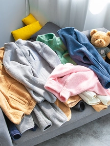 Detail of multi-color teddy fleece jackets with high collar and chest zipper pockets