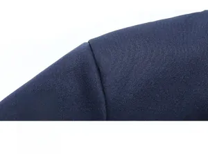 Detailed close-up showing precision shoulder seams on dark blue sports jacket