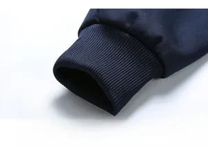 Detail shot of navy blue ribbed cuffs on a men's athletic jacket with tight elastic texture