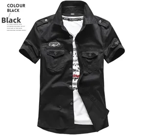 Detail of black military style short sleeve shirt with double chest pockets and embroidered patches