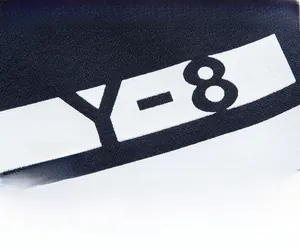 Close-up of Y-8 graphic print on navy blue knit tracksuit with high-quality texture