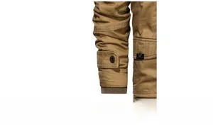 Detailed macro view of khaki work jacket ribbed cuffs with button straps and metal zipper