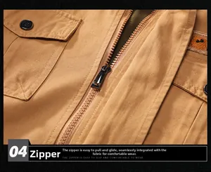 Detailed macro view of khaki cotton jacket showing metal zipper and orange embroidery