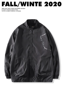 Detail view of black oil wax cow leather jacket with YSLB logo and stand collar