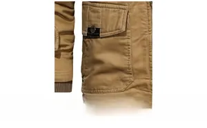 Close-up of khaki utility jacket showing washed cotton fabric and 3D cargo pockets