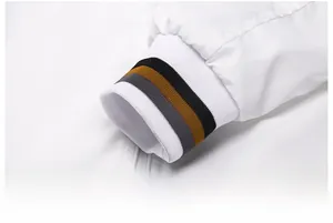 Detail of elastic ribbed cuff on white jacket with black, grey, and brown stripes