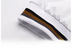 Close-up of white jacket hem with elastic striped ribbing in black and brown