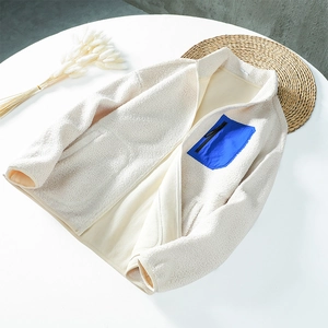 Winter teddy fleece jacket in off-white with blue nylon chest pocket and stand collar