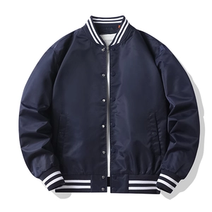 Detail of navy blue pilot jacket featuring striped ribbed cuffs and silver metal snap buttons