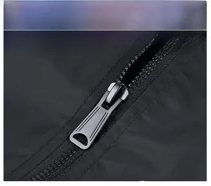 Close-up of durable gunmetal zipper on black embroidered bomber jacket fabric