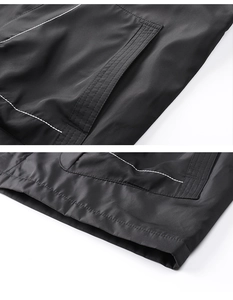 Close-up of black jacket with white contrast stitching and smooth technical fabric finish