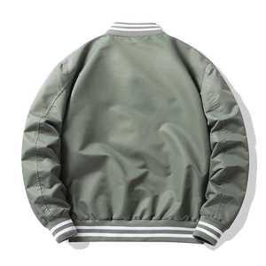 Back view of sage green nylon bomber jacket featuring black and white striped ribbed cuffs