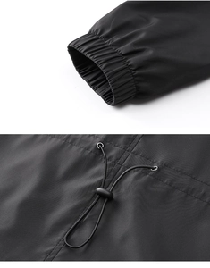Detailed macro shot of elastic ribbed cuffs and plastic drawstring toggles on black jacket