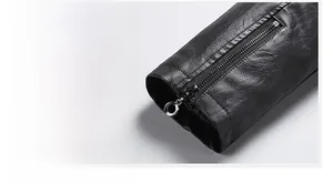 Detail view of black faux leather jacket cuff with functional metal zipper and ring puller