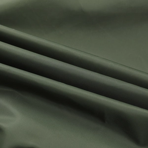 Macro shot of durable olive green nylon flight jacket fabric with subtle twill texture