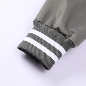 Detailed macro view of the olive green flight jacket cuff with white striped ribbing