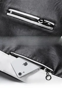 Detail of faux leather jacket featuring black and white contrast and silver metal zippers