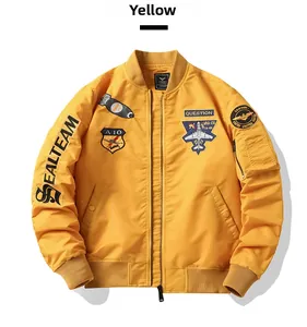 Detail of yellow MA-1 bomber jacket featuring military embroidery and ribbed cuffs