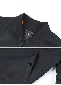 Detail of bomber jacket showing ribbed collar, military label, and orange lining