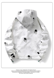 Detail of white hooded jacket showing astronaut prints and adjustable velcro cuffs