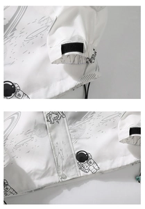 Detail of adjustable velcro cuffs and drawstring hem on a space-themed astronaut print jacket