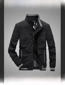 Detail of black stand-collar jacket featuring striped ribbed cuffs and geometric lining