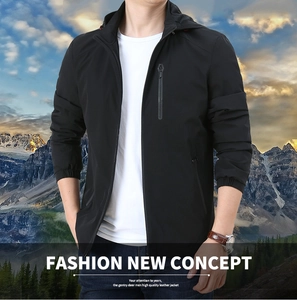 Detail of a black men's hooded jacket featuring a chest zipper pocket and elastic cuffs