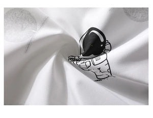 Detail of white fabric with a black and gray cartoon astronaut print and planetary motifs
